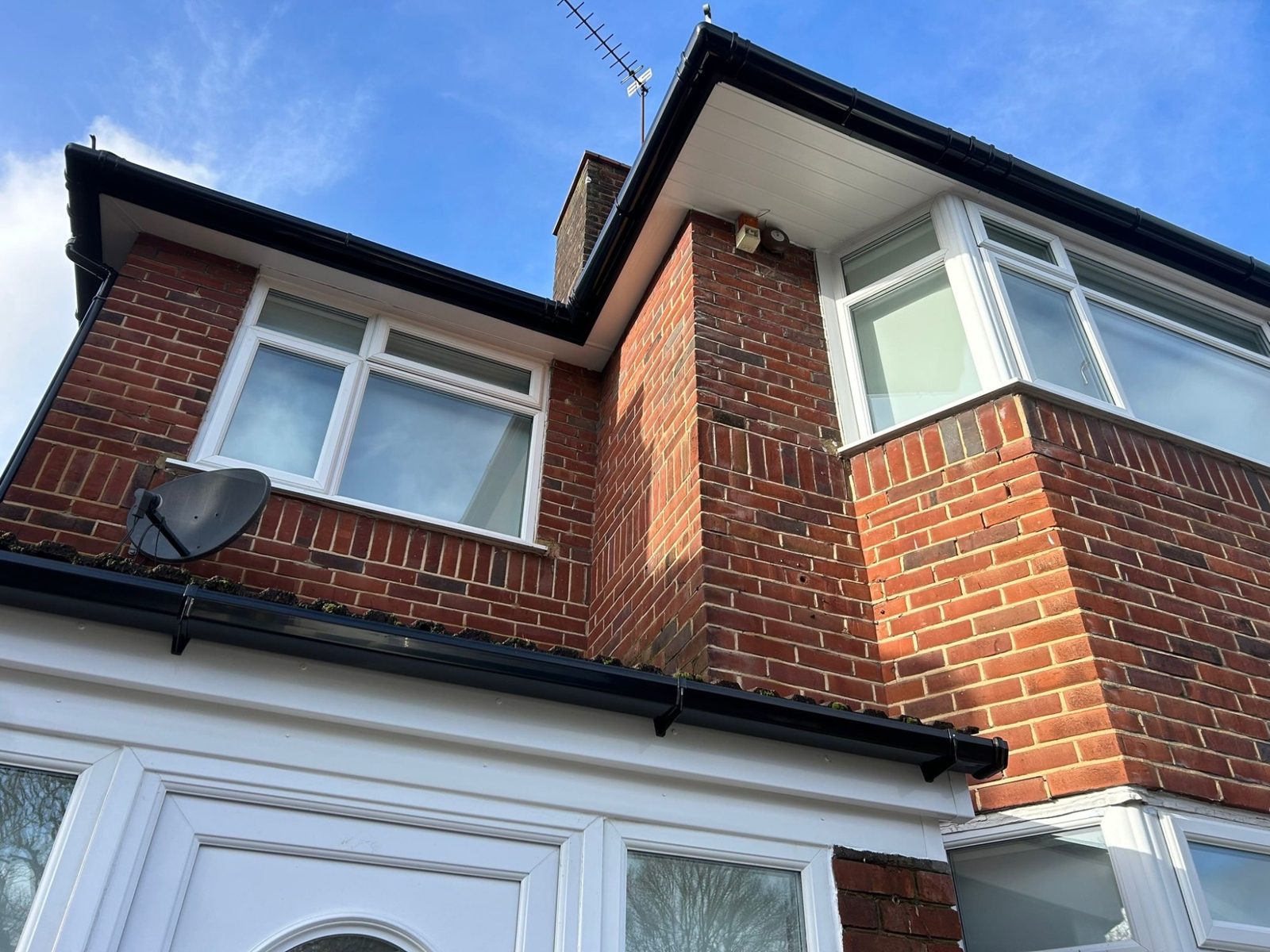 New white UPVC fascia and soffit on a brick house