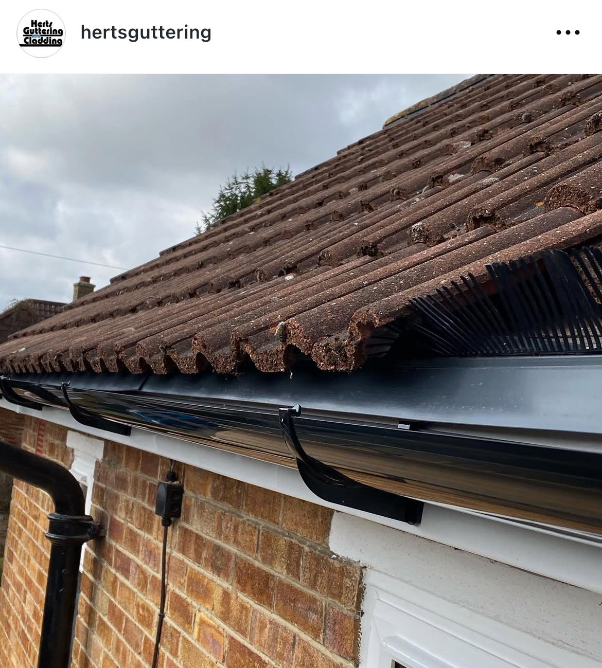 New black guttering on a tiled roof